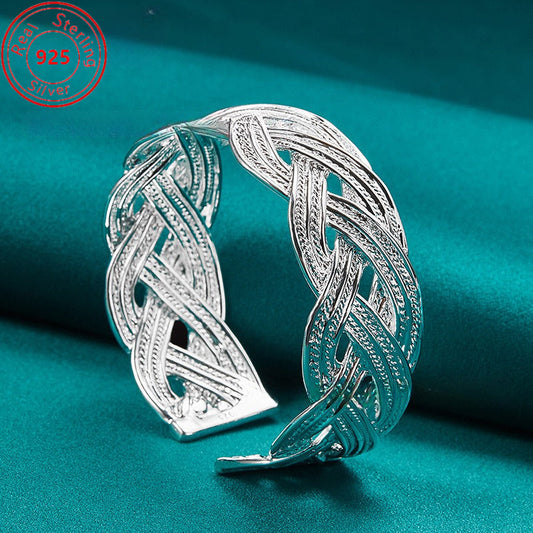 This bracelet is made of 925 sterling silver and features a woven design that is both stylish and elegant. It is adjustable and perfect for everyday wear, parties, birthdays, and Thanksgiving. This trendy piece of jewelry is a perfect gift for any female