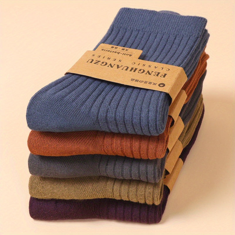 Five pairs of men's cotton crew socks in assorted colors. Breathable, sweat-absorbing, mid-calf length suitable for business and casual wear. Cute socks.