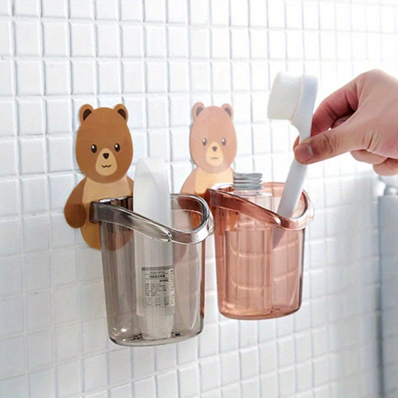 Adorable bear toothbrush cup with toothpaste storage rack and plastic holder, perfect for organizing bathroom essentials in small spaces. Great for home, dorms, and college dormitories.