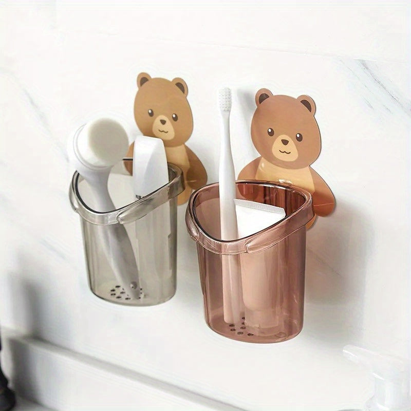 Adorable bear toothbrush cup with toothpaste storage rack and plastic holder, perfect for organizing bathroom essentials in small spaces. Great for home, dorms, and college dormitories.