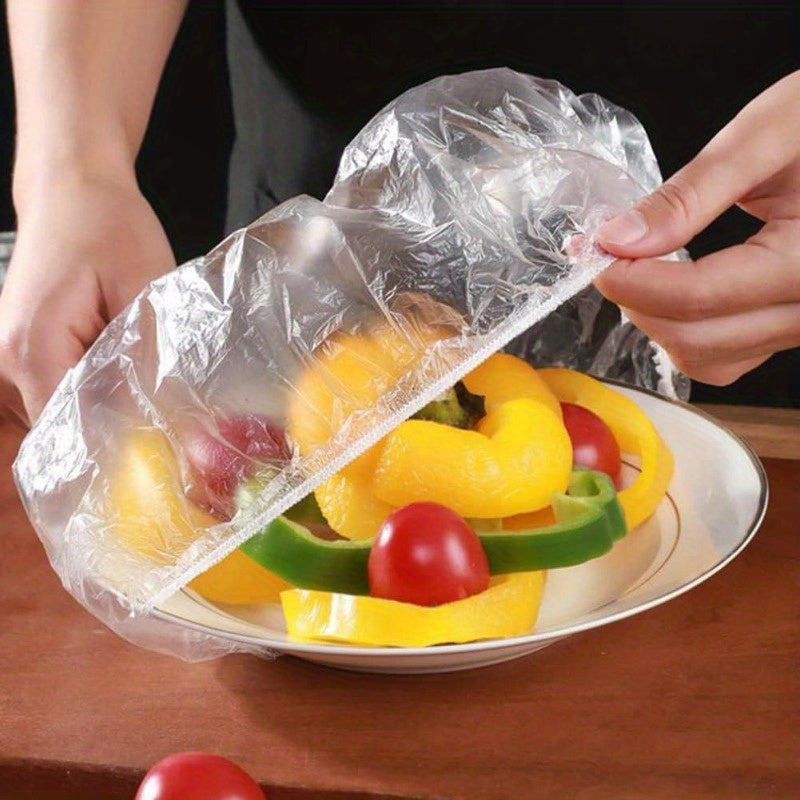 Collection of 100 durable cling bags for storing food, sealing bowls, and wrapping fruit. Ideal for picnics, hotels, leftovers, and outdoor use. Can also double as a see-through shower cap for hair salons and restaurants.