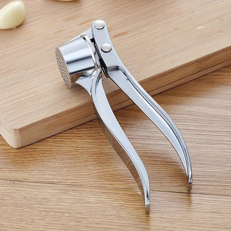 Premium stainless steel garlic press for easy crushing without electricity.