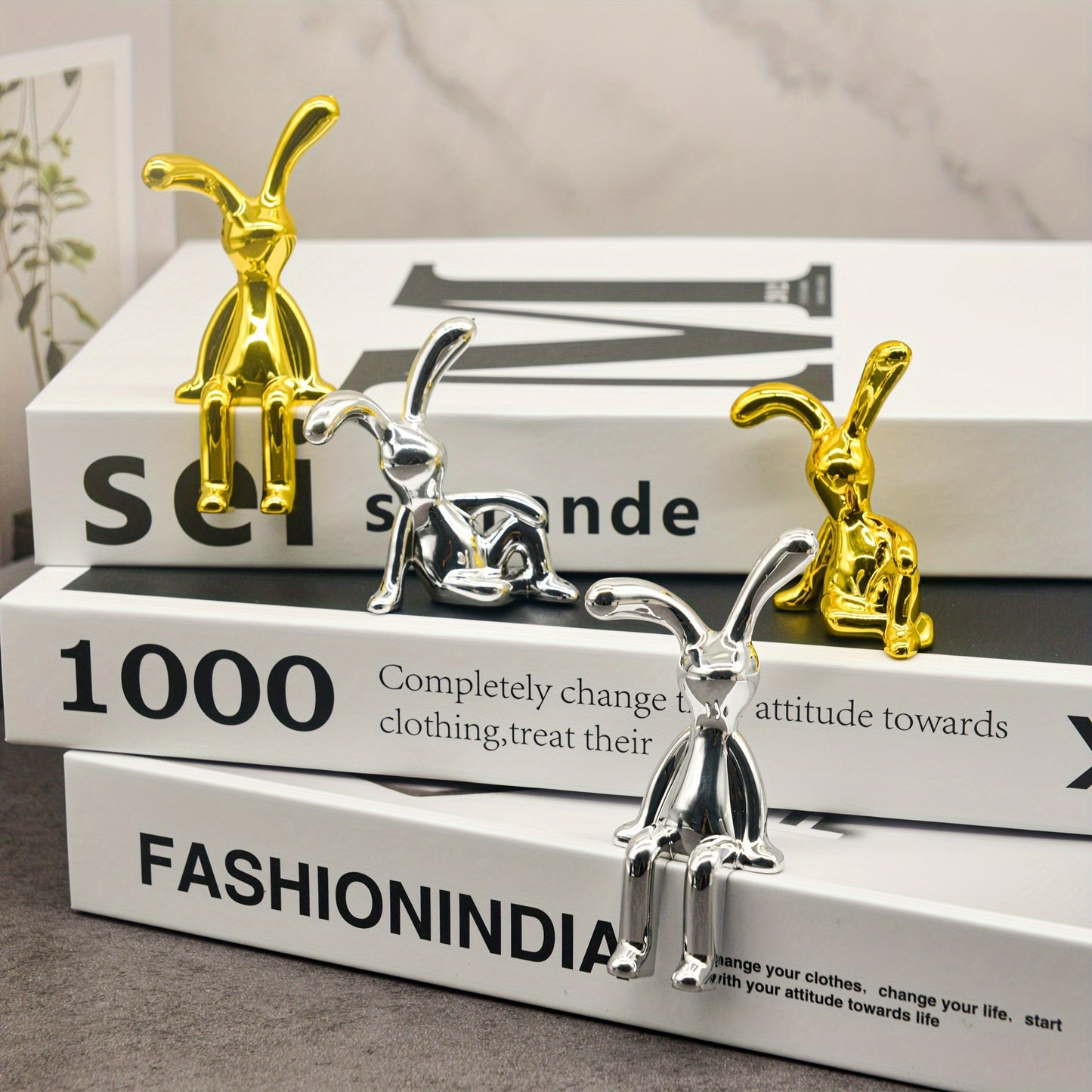 Golden and silver sitting rabbit figurines - Elegant bunny statues for home, office, and cafe decor.