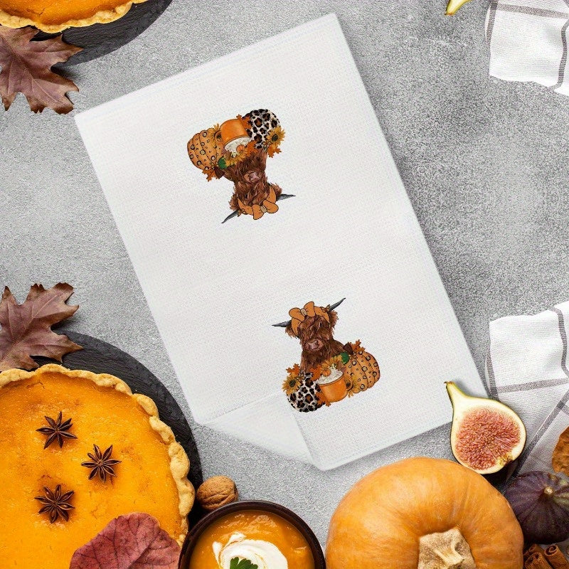 Western Autumn-themed kitchen towel, featuring cow and leopard print, pumpkins, coffee cups, and maple leaves. This decorative hand towel can be used in the bathroom or kitchen to add a touch of fall charm.