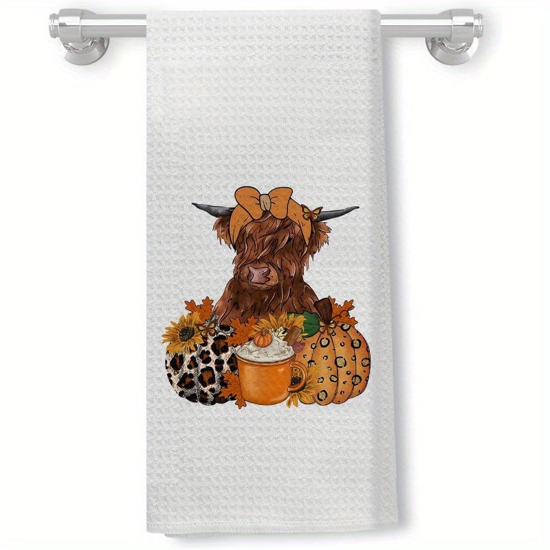 Western Autumn-themed kitchen towel, featuring cow and leopard print, pumpkins, coffee cups, and maple leaves. This decorative hand towel can be used in the bathroom or kitchen to add a touch of fall charm.