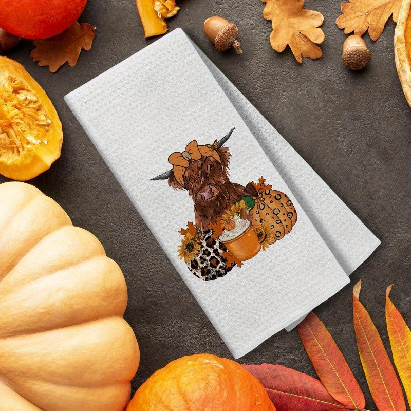 Western Autumn-themed kitchen towel, featuring cow and leopard print, pumpkins, coffee cups, and maple leaves. This decorative hand towel can be used in the bathroom or kitchen to add a touch of fall charm.