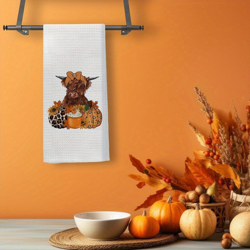 Western Autumn-themed kitchen towel, featuring cow and leopard print, pumpkins, coffee cups, and maple leaves. This decorative hand towel can be used in the bathroom or kitchen to add a touch of fall charm.