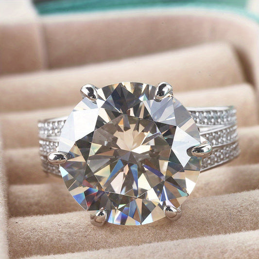 This elegant and trendy jewelry piece features a 10 carat round cut Moissanite stone set in 6.7g of sterling silver. Hypoallergenic and perfect for a Christmas or birthday gift, this Moissanite ring is designed for durability and style. With its elegant