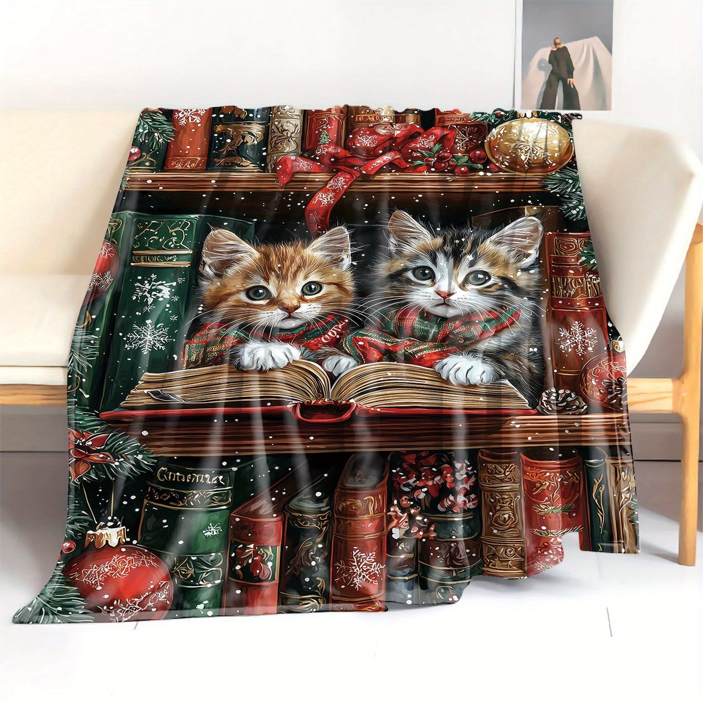 One piece of a mid-century style flannel blanket featuring Christmas kittens reading on a shelf. This soft knit throw weighs 200-250g and is digitally printed. Perfect for use on a bed, sofa, office, or while camping, this all-season blanket has a