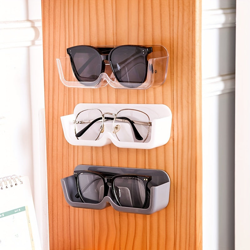 Sleek wall-mounted glasses display stand in light gray made of durable plastic. This space-saving organizer is perfect for eyewear and fashion glasses, ideal for bedside or desk use. Features a classic style.