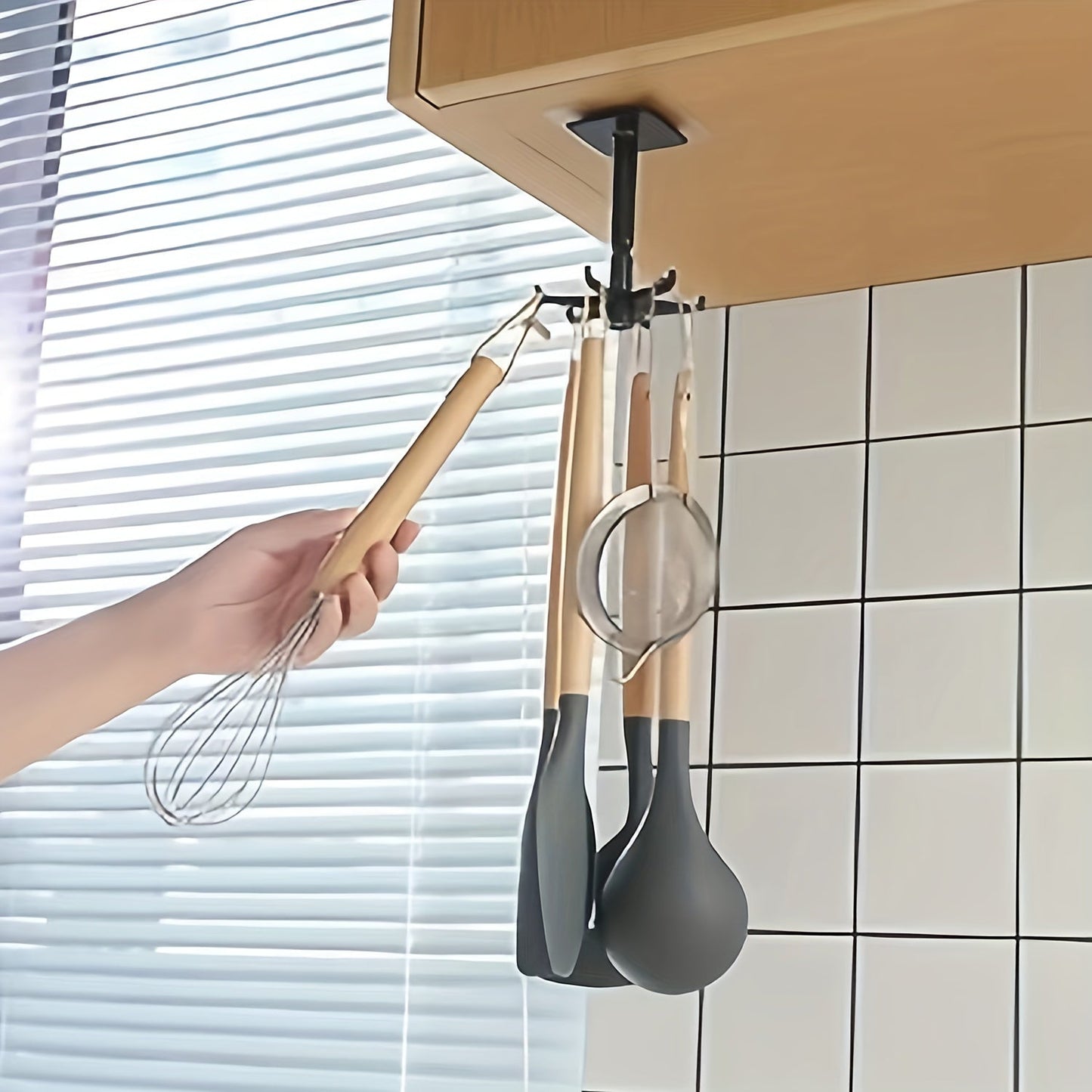 Mount this 1pc Rotatable Plastic Utensil Holder on your wall and save space in your kitchen. The strong adhesive hooks provide secure storage for cooking tools under your cabinet. Its portable wall hanging design in black is both functional and stylish.