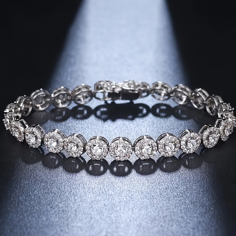 A timeless and sophisticated silver tennis bracelet featuring Moissanite gemstones, exuding a sultry charm and versatile appeal for year-round wear. This stunning piece is perfect for daily adornment or as a thoughtful gift, made with silver plating and