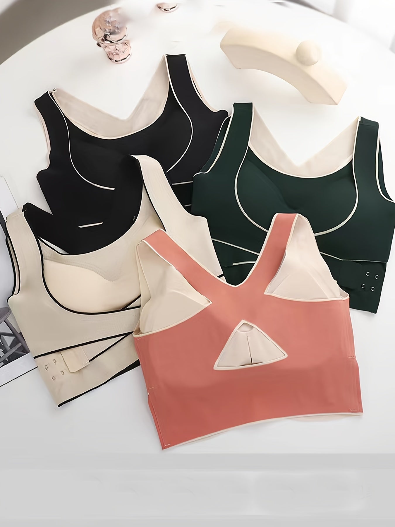 4 Women's front-closure sports bras with attractive back design for running and yoga.