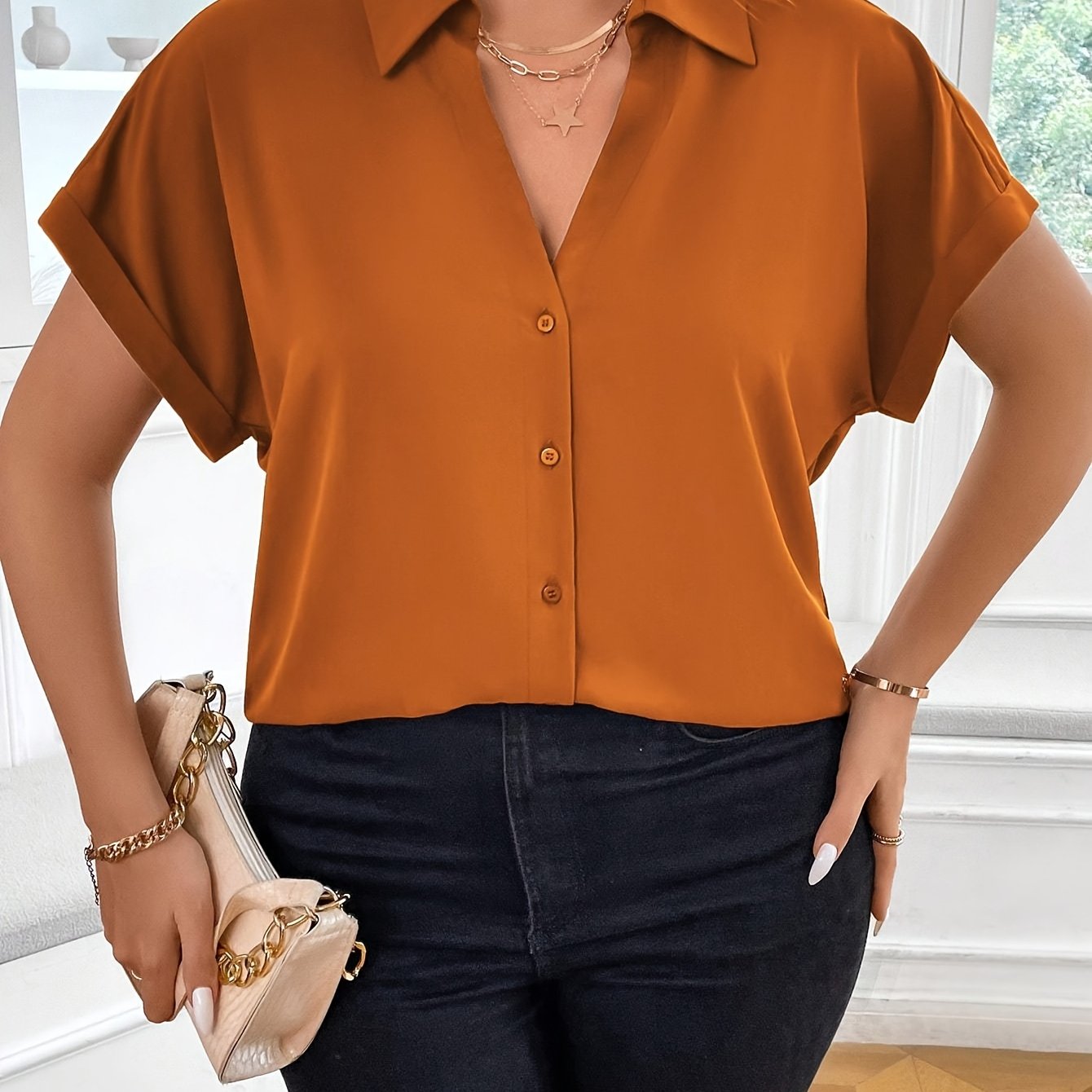 Plus size solid collared blouse with short sleeves and button details, perfect for spring.