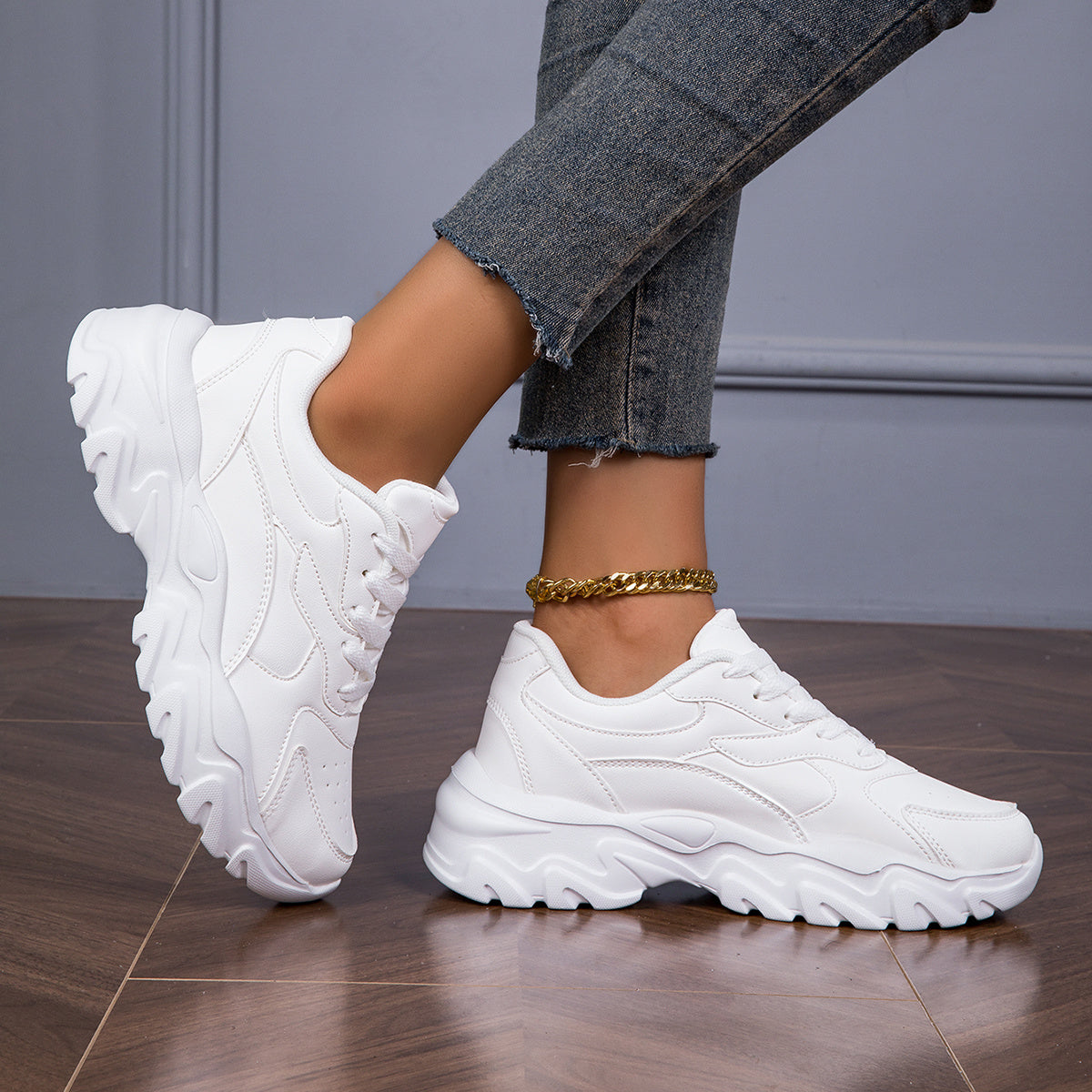 Women's white low-top lace-up sneakers for casual walks and shopping.