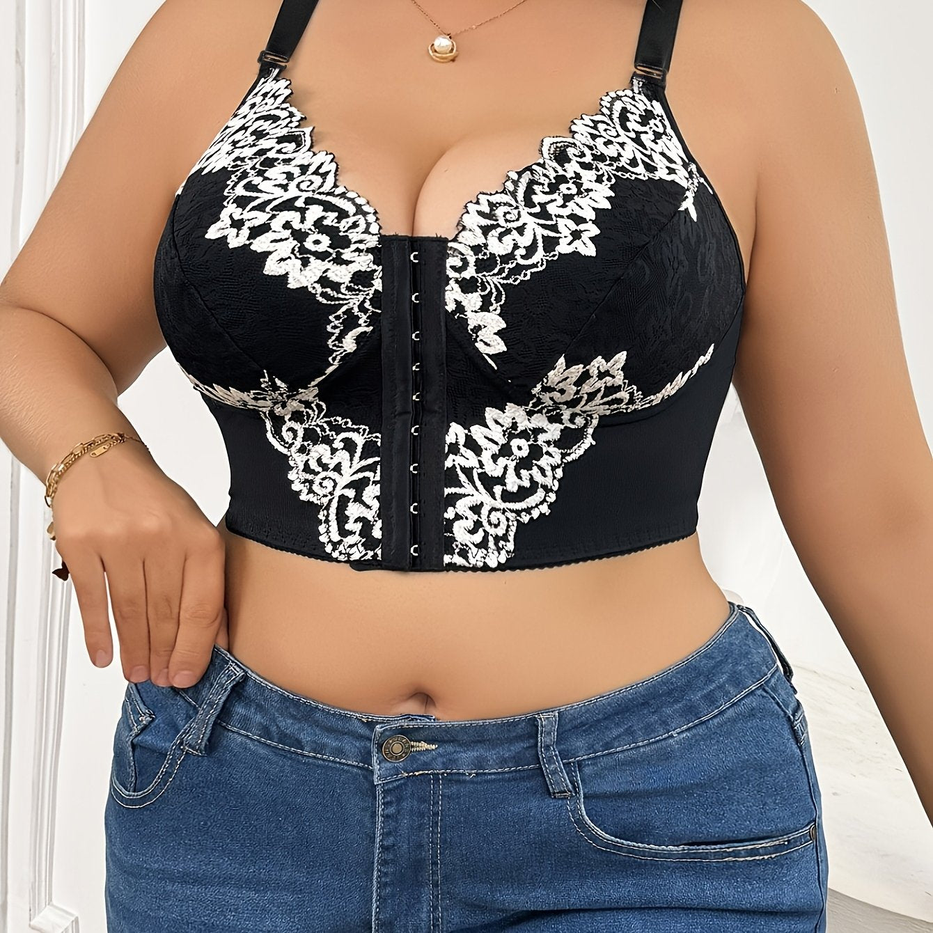 Plus size lace front-closure bra with floral print and contrasting lace detail, wide shoulder straps for comfort. Hand washable fabric in black and white.