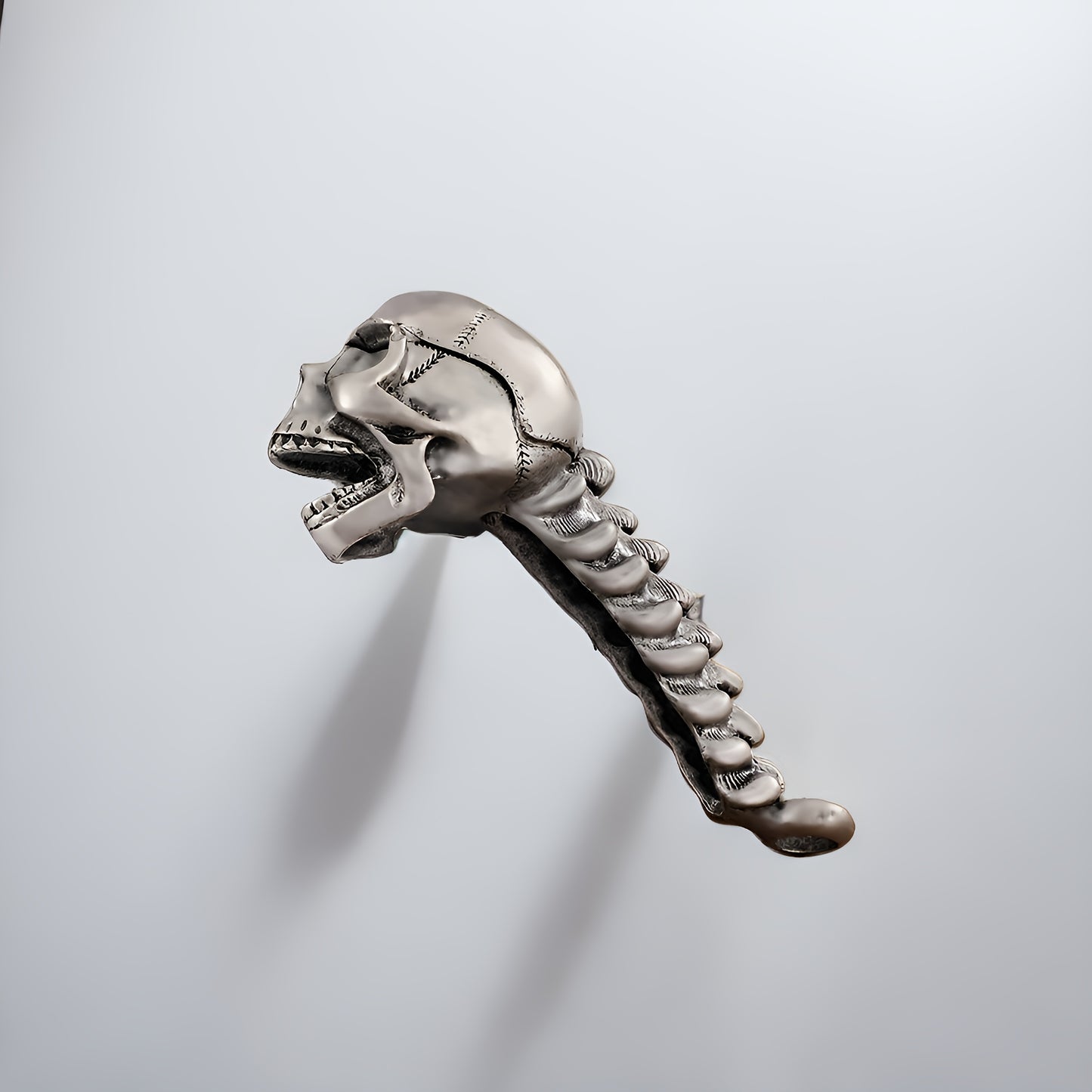 Skull-shaped metal bottle opener for beer and juice, perfect for home and restaurant use.