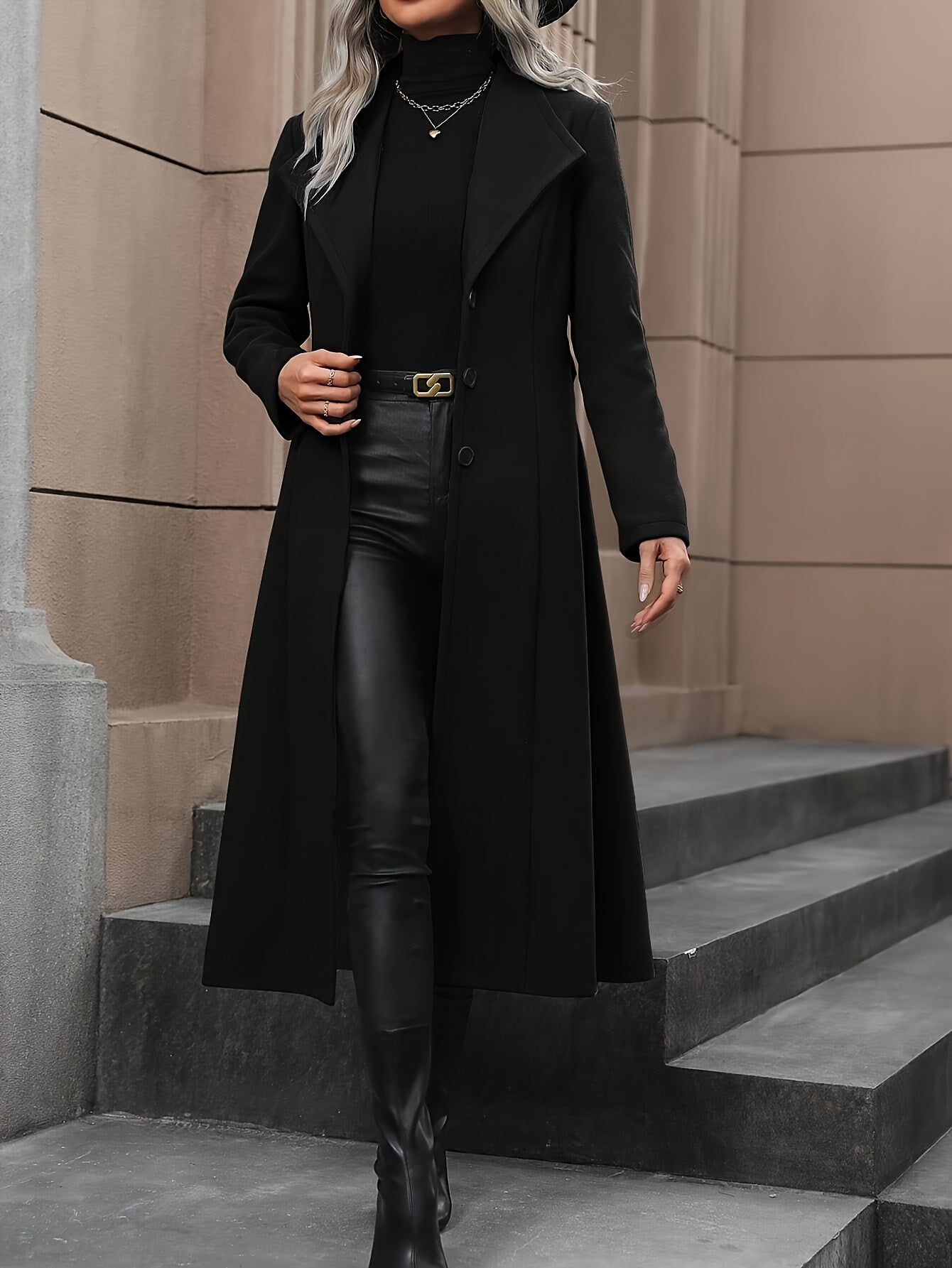 Stylish black trench coat with belt for women's fall/winter outerwear collection.