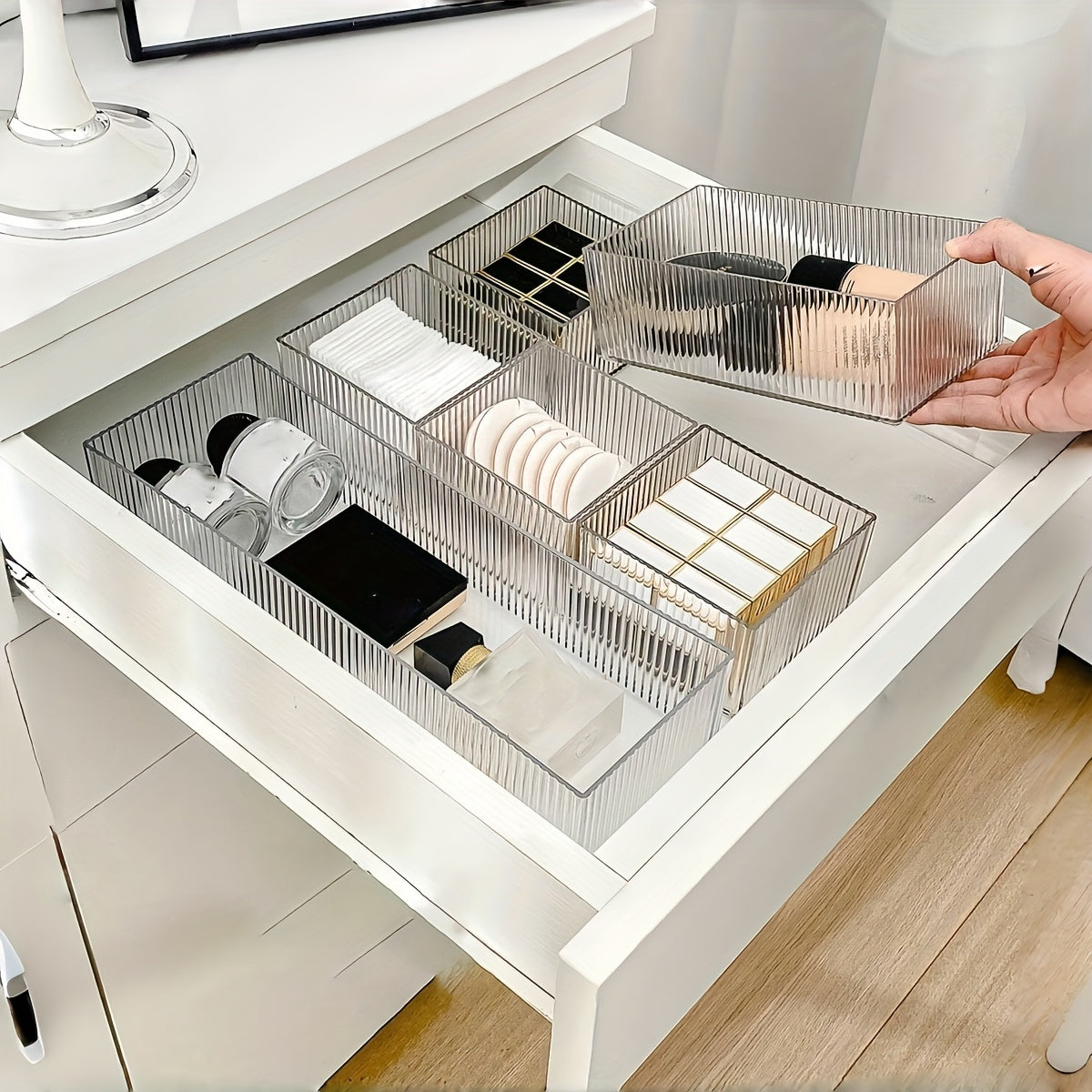 Clear plastic organizer set with customizable drawers for cosmetics and various storage needs, suitable for multiple spaces.