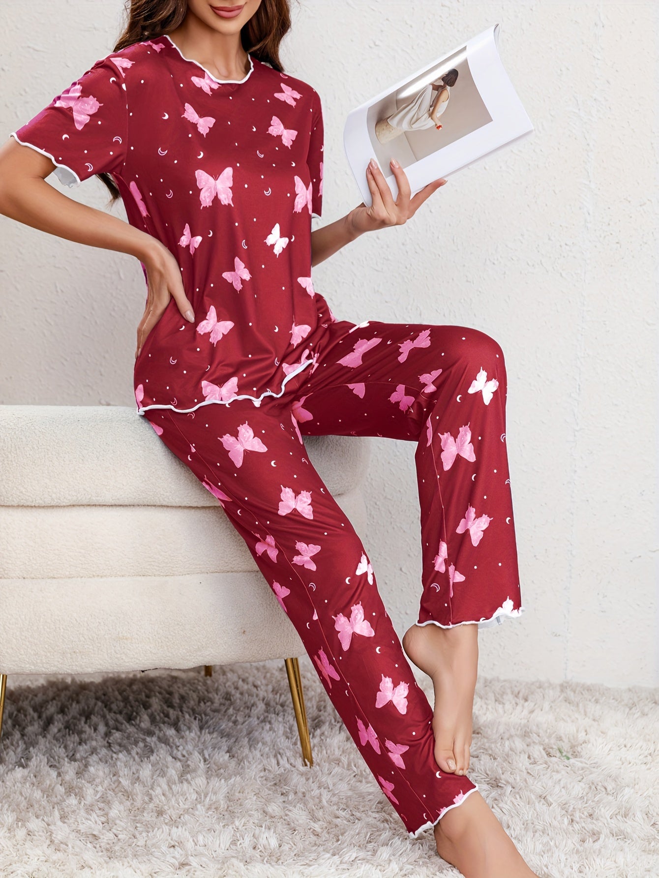 Butterfly print lounge set for women with lettuce trim, short sleeve top, and pants.