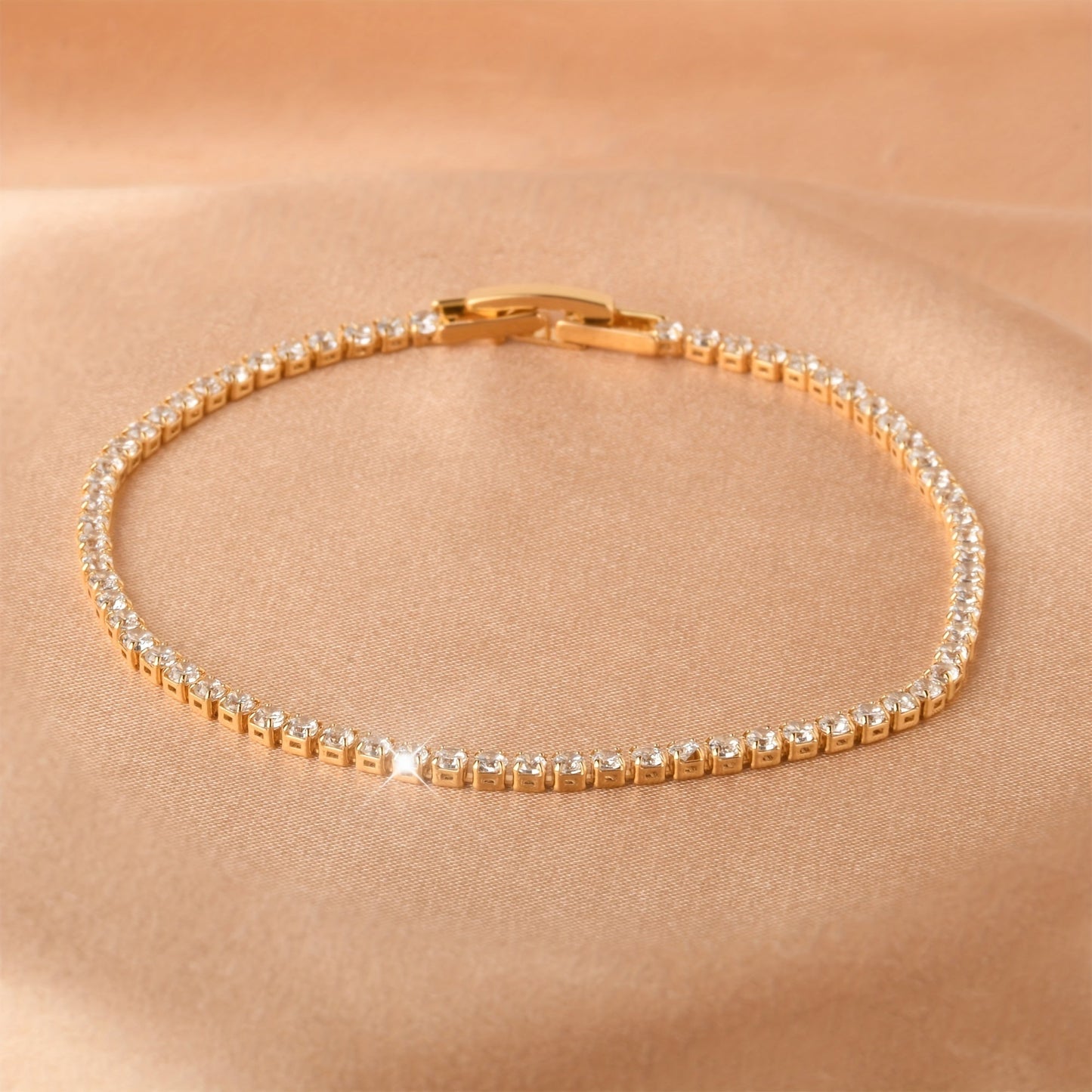 Golden plated copper hand jewelry accessory, featuring inlaid shiny zirconia stones in a tennis bracelet design. Perfect gift for Mother's Day.