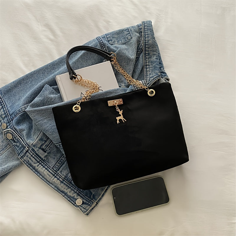 Stylish deer pendant women's tote bag with large capacity, golden-tone chain straps, black color, magnetic closure, versatile for everyday use.