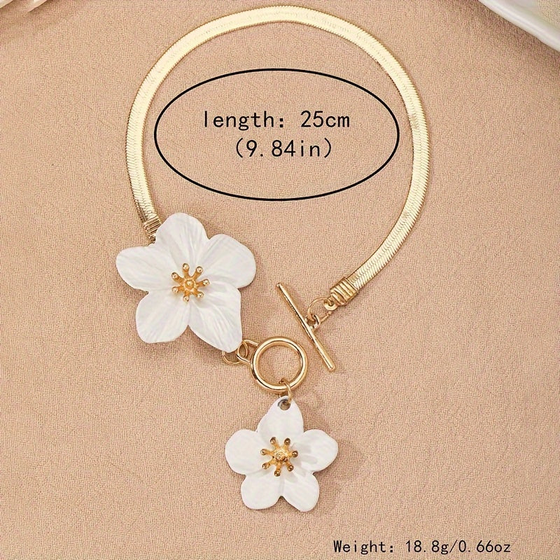 Stylish gold-tone anklet with white flower charms, perfect for vacations and everyday wear.