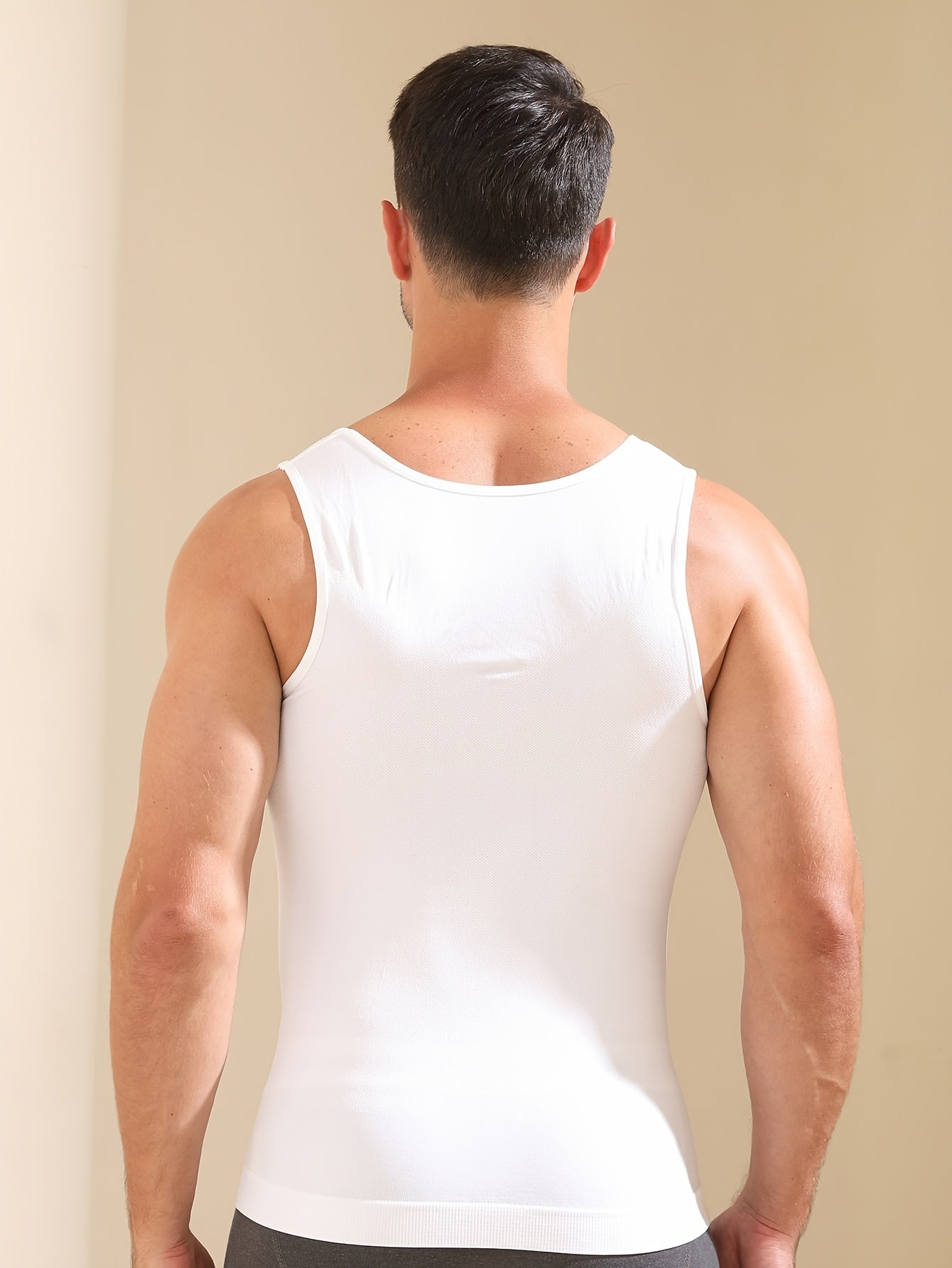 Men's body shaping tank top with breathable fabric, wide shoulder straps, designed to slim waist and chest.