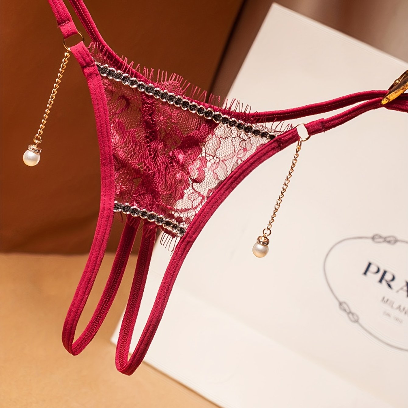 Floral lace thong with pearl pendant, open crotch design, low waist lingerie for women.