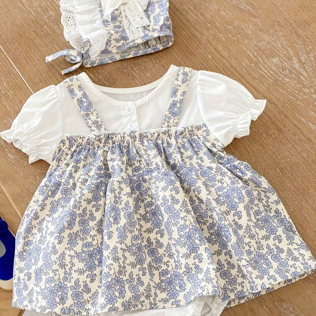 Baby's floral pattern romper dress with puff sleeves and matching hat, perfect for outdoor wear for toddler and infant girls.