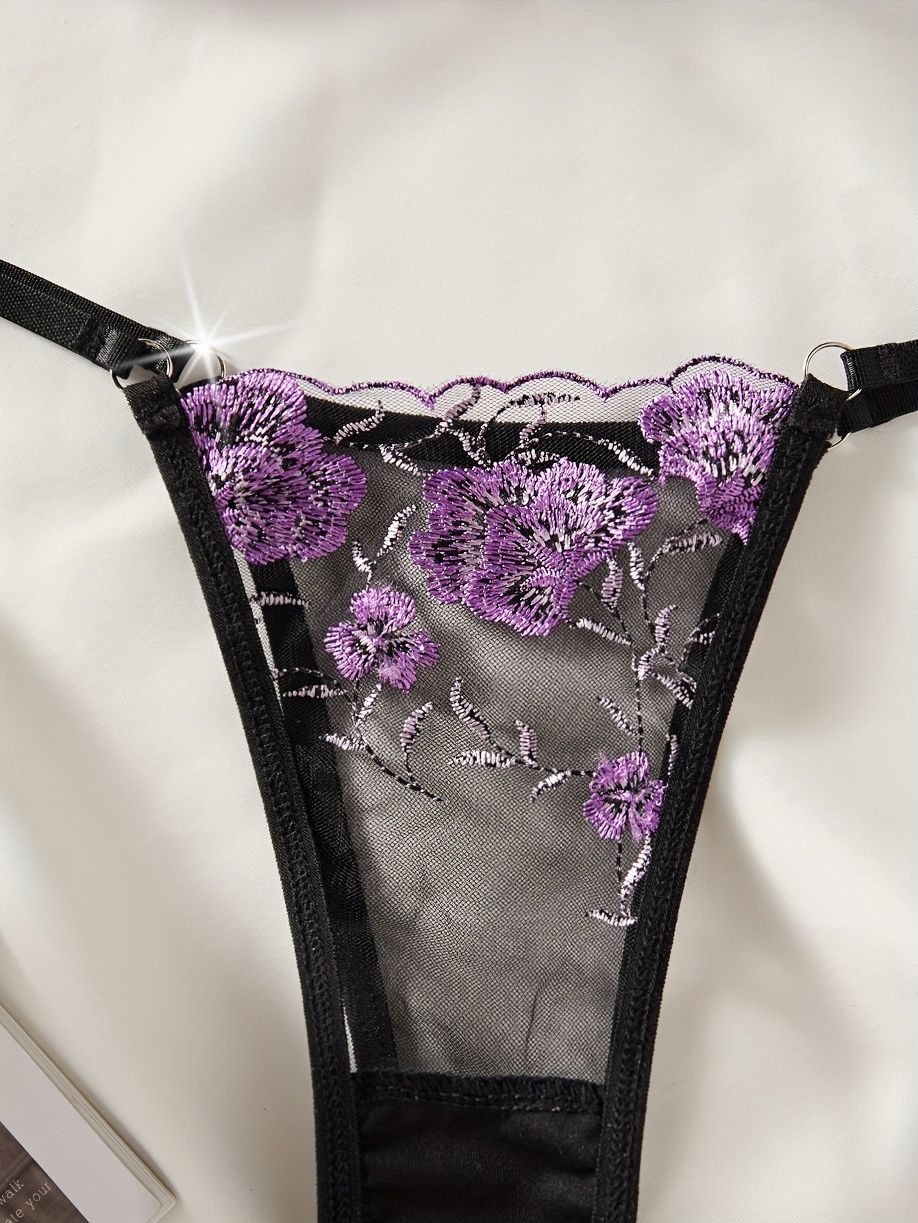 Floral embroidered lingerie set with sheer mesh bra and thong for women.