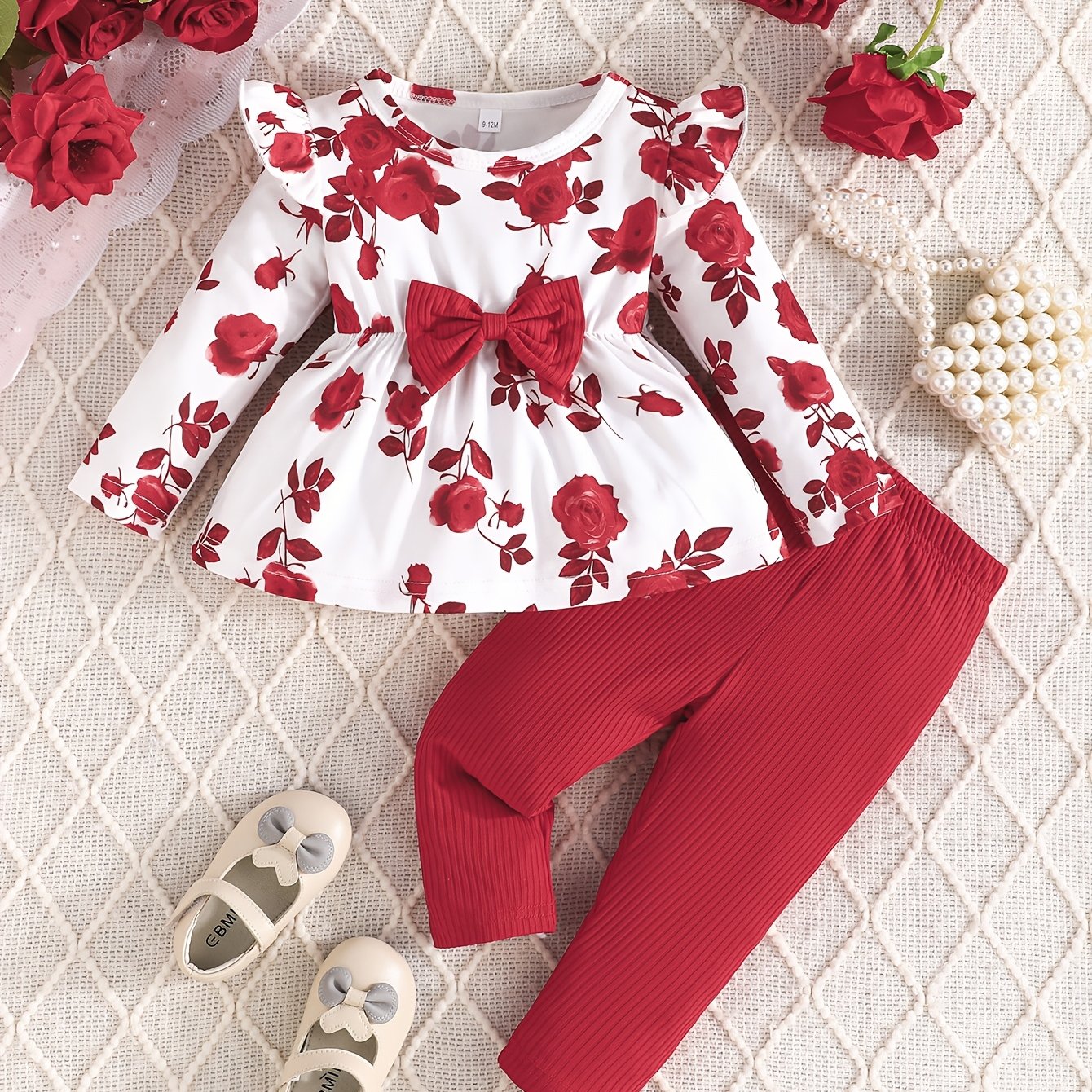 Girls' floral print top with bow detail and matching pants set in cute polyester knit fabric. Regular fit for outdoor activities.