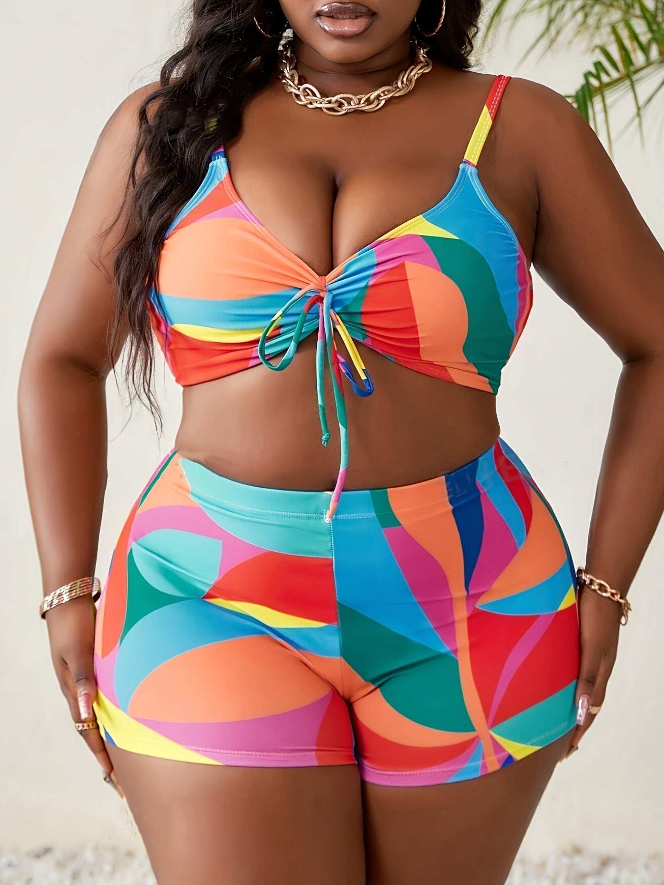 Plus size bikini set with geometric print, high stretch, and drawstring detail for women; includes V-neck top with removable padding.