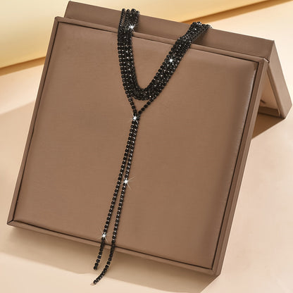 Elegant and luxurious, this black and white tassel necklace features shiny rhinestones, making it the perfect accessory for bridal events and weddings. Delicate and stylish, this multi-layer necklace is an ideal gift for any occasion.