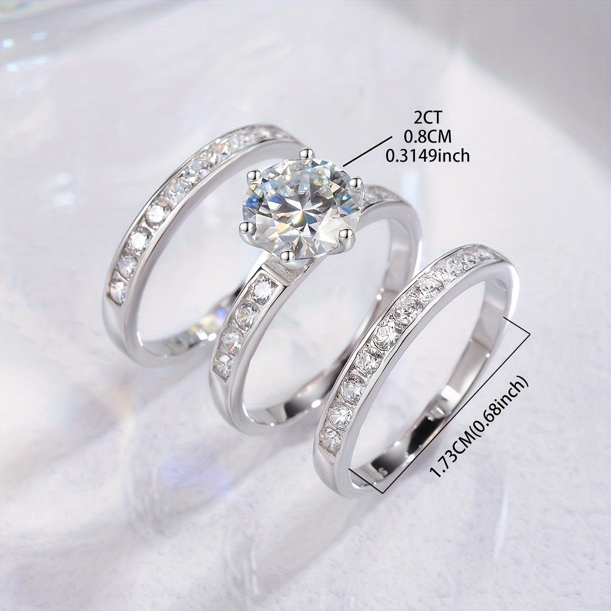 This luxurious ladies' jewelry set features a 2-carat Crown three-piece Moissanite diamond engagement ring set made of 925 sterling silver. The set includes a promise ring, eternal ring, anniversary ring, and Valentine's Day gift. The Moissanite stone