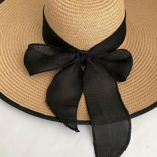 Casual wide brim sun hat with bow, ideal for stylish sun protection at the beach.