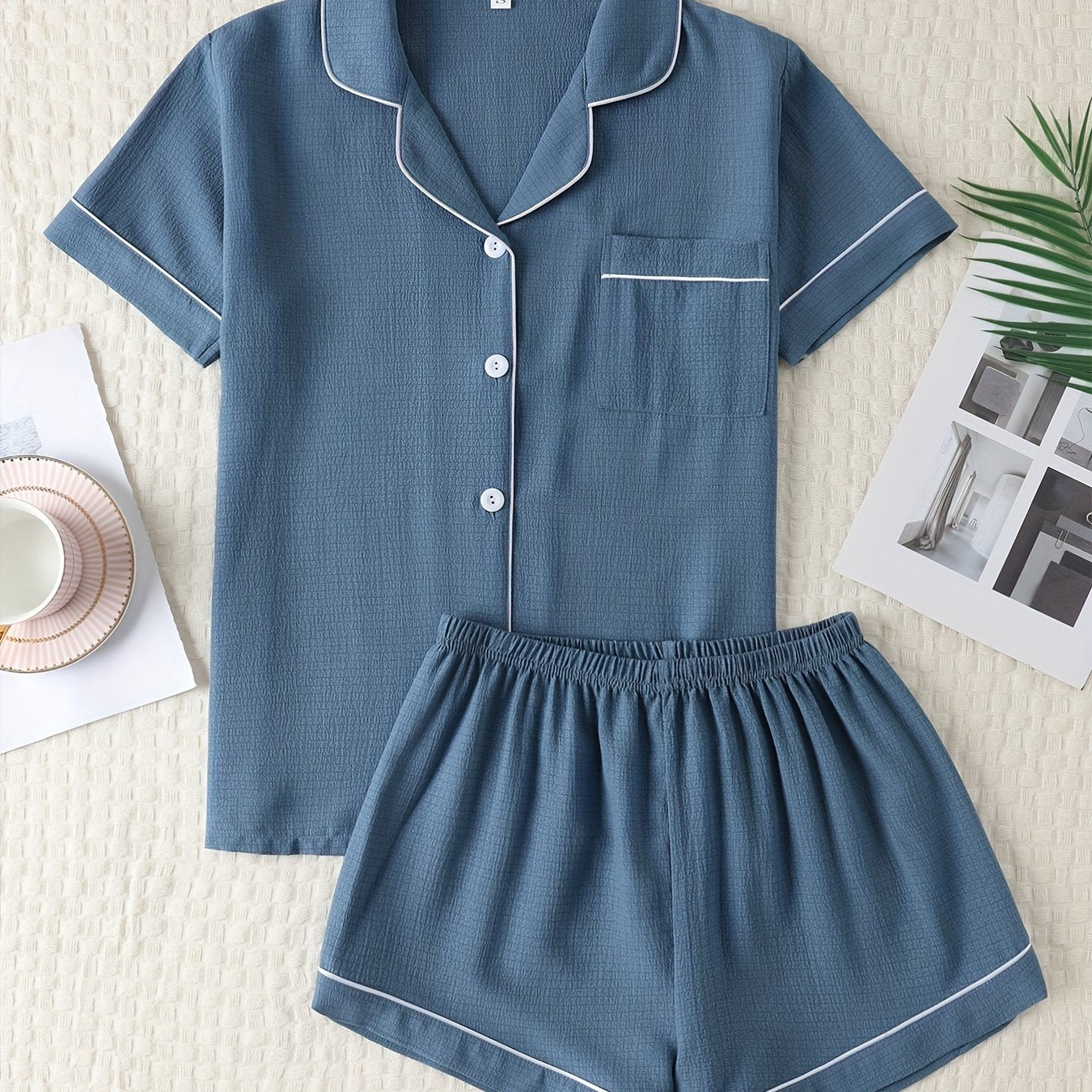 Basic pajama set for women, featuring a short-sleeve button-up top with lapel collar and elastic shorts.