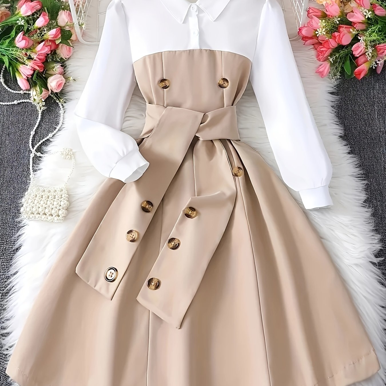 Stylish girls' black and white color block dress with belt and button details, perfect for school or casual wear. A-line silhouette made from a machine washable polyester blend. Suitable