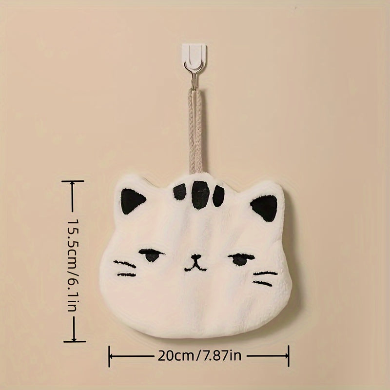 Cute cat-shaped hand towel made of soft coral fleece material with quick-dry feature, suitable for use in bathroom and kitchen with its hanging design.