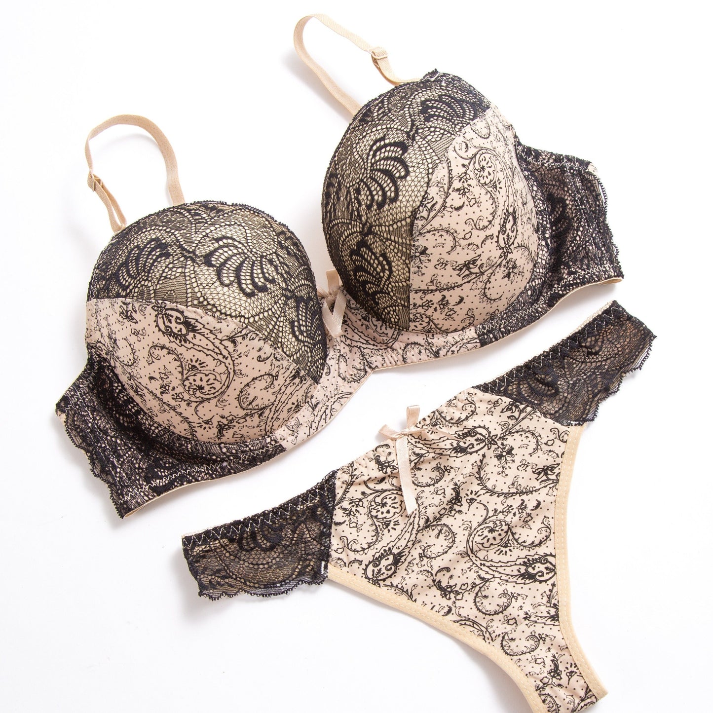 Sophisticated lace bra and panty set in beige and black floral print. Hand washable nylon blend for comfort and versatility. Perfect for casual wear or special occasions. Smooth texture