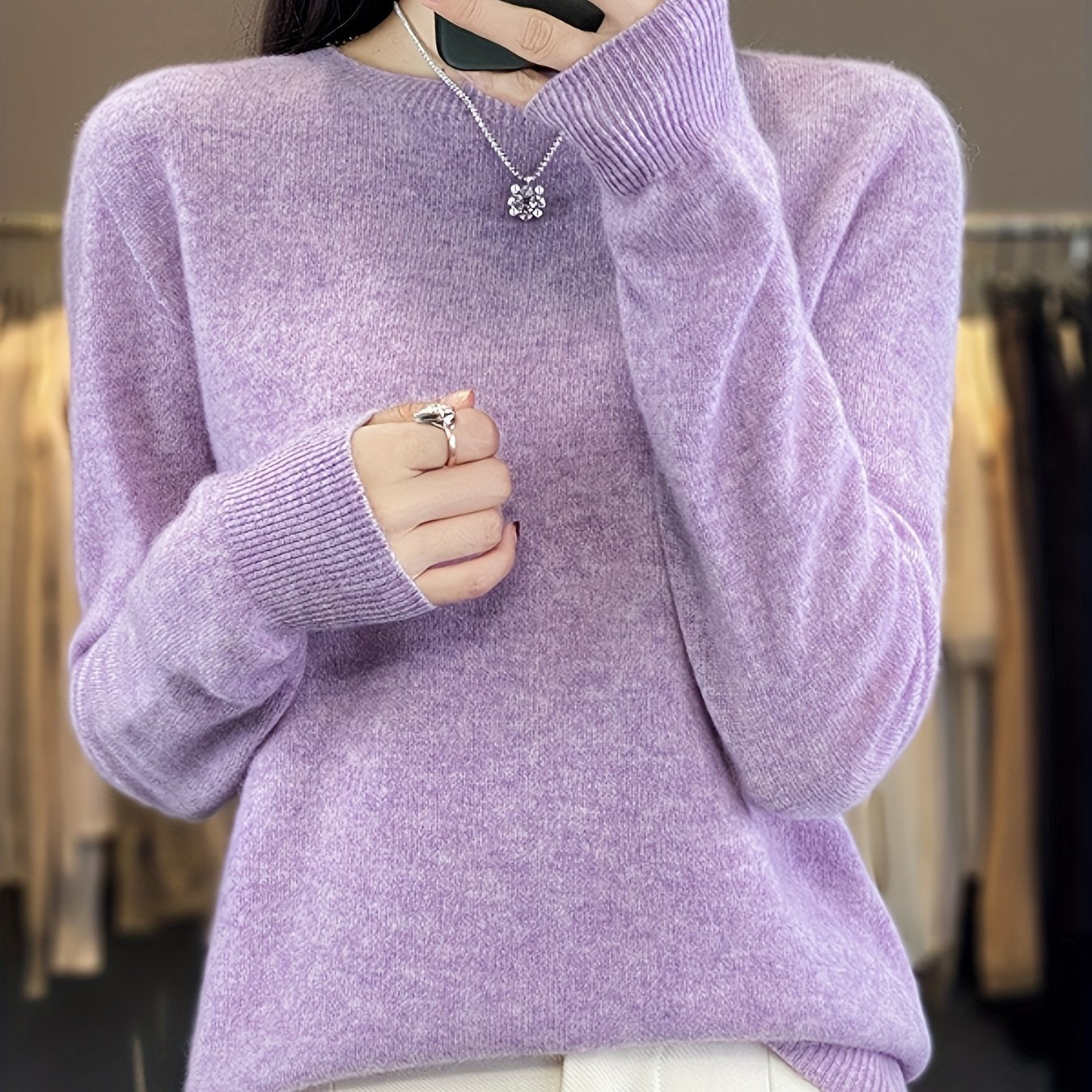 Stylish women's merino wool sweater with cozy crew neck, long sleeves, and solid color knit design for fall/winter.