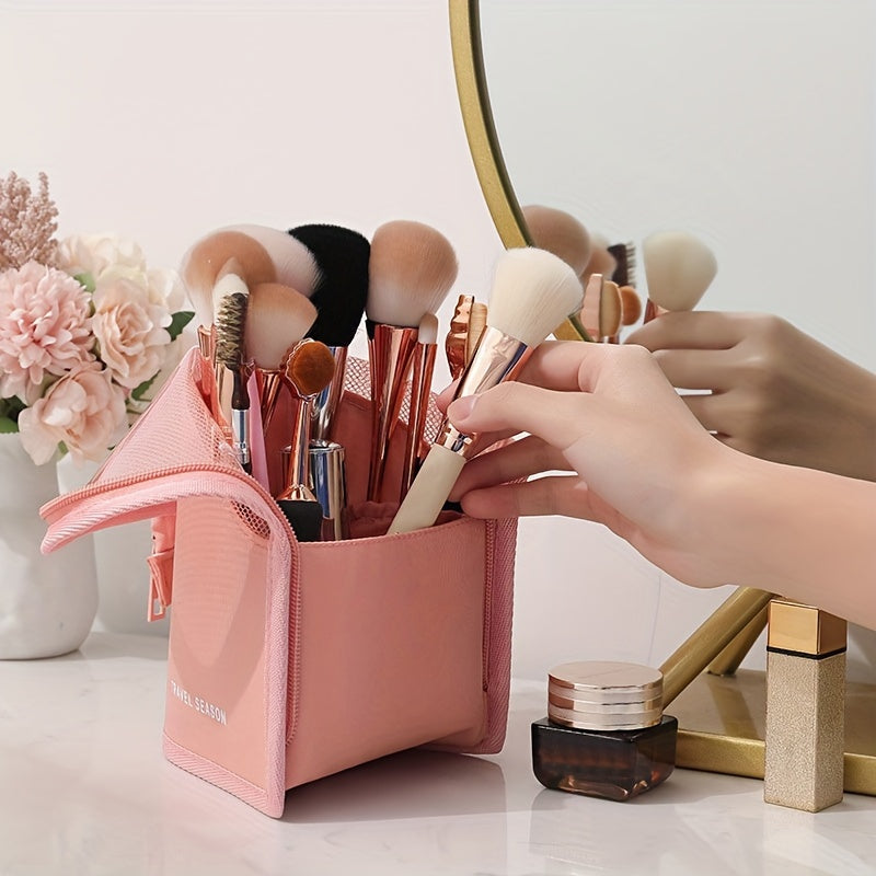 Waterproof wash bag with travel-friendly makeup brush storage, compartmentalized cosmetic storage, and a clear, transparent design.