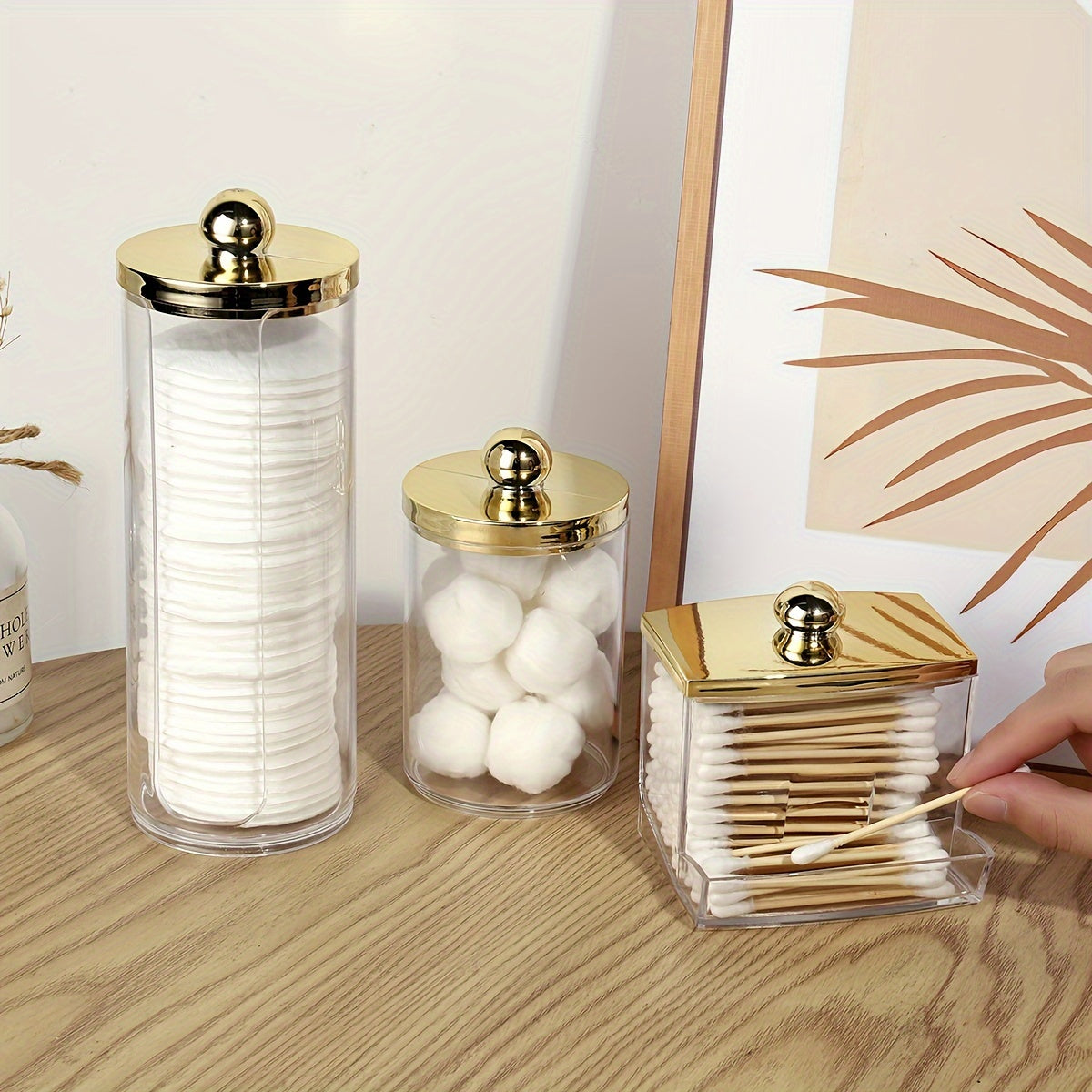 Bamboo-lidded cotton pad holder for bathroom organization.