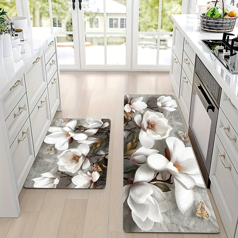 Handcrafted from durable polyester material, this elegant White Magnolia Floral Kitchen Mat features a non-slip design to ensure safety in high traffic areas. With a thickness of 1cm, this machine-made rectangular floor carpet is perfect for bedrooms