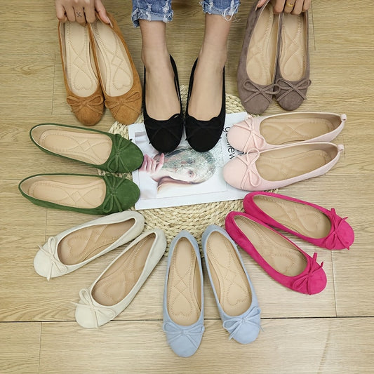 Women's bowknot flat shoes in solid color suedette, slip-on style with soft sole.