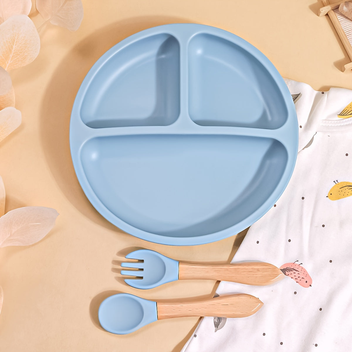 TYRY.HU offers a 3-piece set of baby feeding essentials made from 100% silicone. The set includes a divided suction plate, led weaning set, and plates and utensils set. Perfect for mealtime, this tableware set includes a plate and spoon. Makes a great