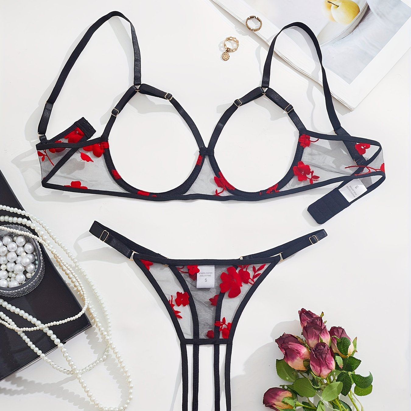 Elegant black and red floral lace bralette and thong set for women.