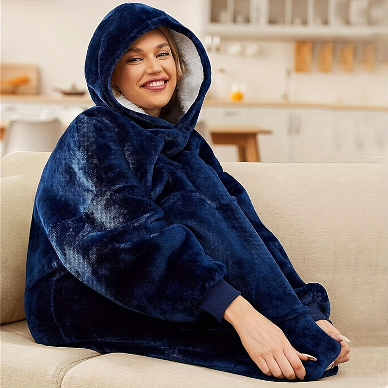 One piece of an oversized hooded blanket made from super soft flannel fabric. This wearable blanket features a stylish hood and a convenient pocket, providing warmth and comfort in cold weather.