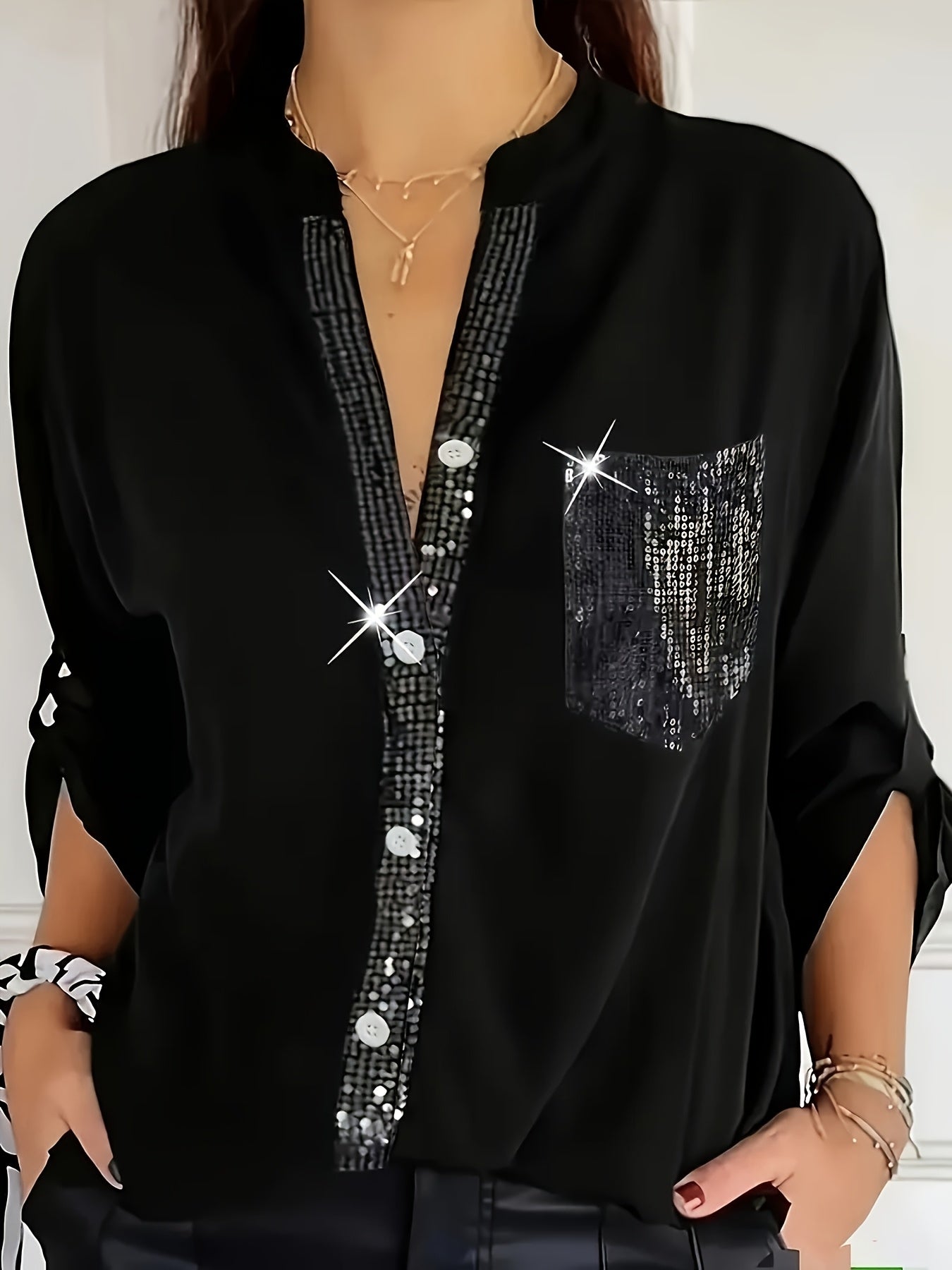 Casual loose V-neck shirt with sequin details, solid color, long sleeves, and an elegant irregular hem for women in spring and autumn.