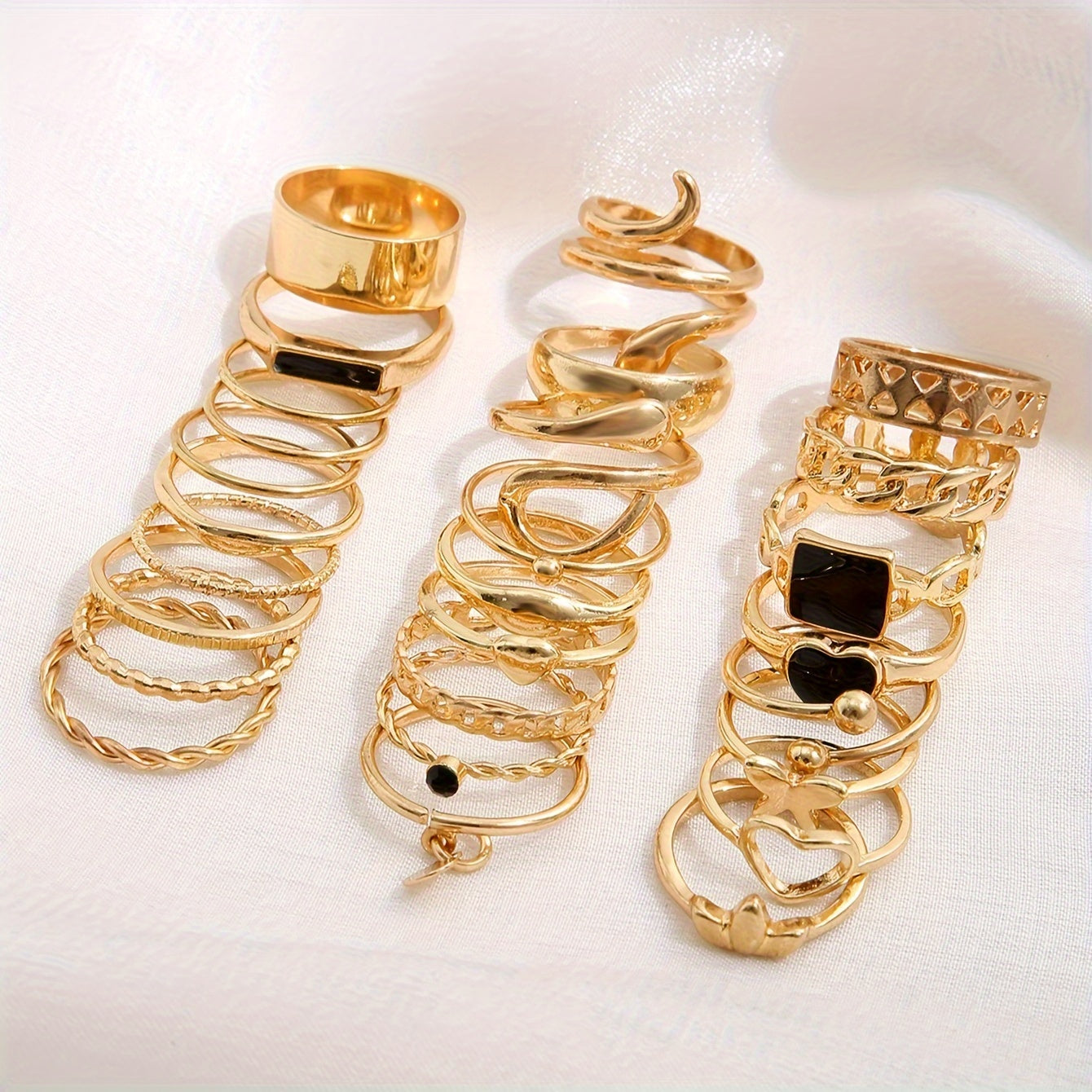 Vintage stackable rings set with 27 pieces made of zinc alloy. Features various designs including hearts, butterflies, snakes, drops, geometric shapes, discs, hollow chains, and wide faces.